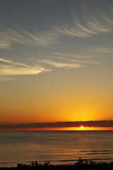 A golden sunrise on the beach, summer morning.