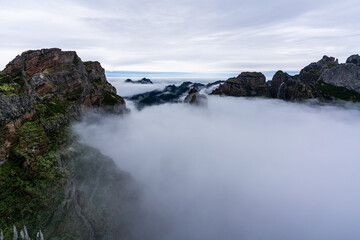 Fototapeta na wymiar Mountain peaks at the height of clouds on Madeira Island