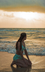 Fototapeta na wymiar yoga on the beach young woman sitting sand beach miami beach horizon sea water sky 