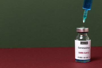 Transparent glass vials with test COVID-19 vaccine, with syringes