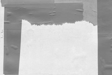 White torn paper collage close-up. Texture made from various paper and cardboard parts. Damaged old...