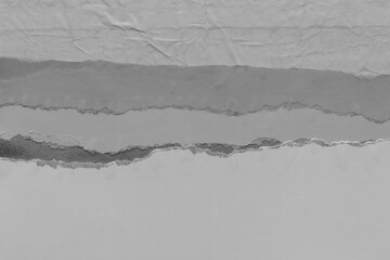 White torn paper collage close-up. Texture made from various paper and cardboard parts. Damaged old paper background. Vintage blank wallpaper. Material design backdrop.