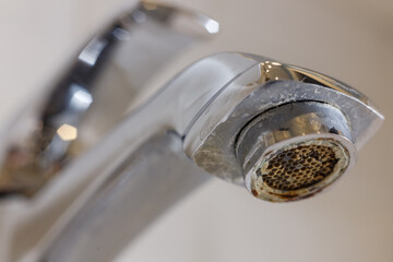 Limescale on faucet mesh in bathrooms. Close up view