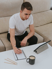 Young man with digital tablet at home