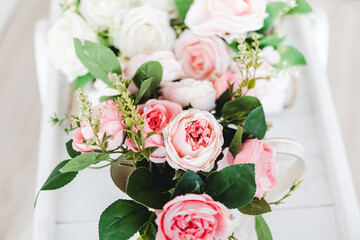 bouquet of artificial peonies on a light background