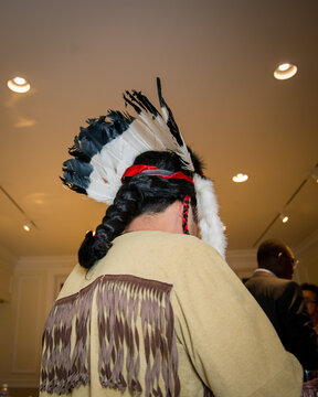 The back of a pilgrim's headdress with braided hair capotain English man