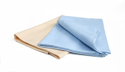 Two folded textile napkins isolated on white background.