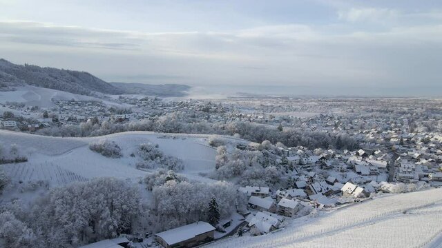 Fly Towards Scenery Of Houses Covered With Snow Near Vineyards At Offenburg In Zell-Weierbach, Germany. - Aerial Drone Shot