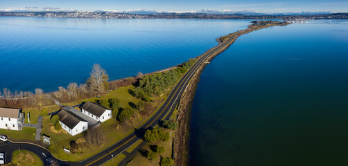 Semiahmoo Spit Leading to the Exclusive Resort and Marina. Aerial view of the Alaska Packer’s Cannery (APA) Museum at Semiahmoo County Park. The Canadian city of White Rock is in the background.