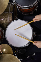 Professional drum set closeup. Man drummer with drumsticks playing drums and cymbals, on the live music rock concert or in recording studio  &nbsp;