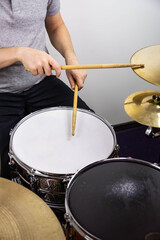 Professional drum set closeup. Man drummer with drumsticks playing drums and cymbals, on the live...