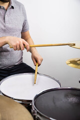 Professional drum set closeup. Man drummer with drumsticks playing drums and cymbals, on the live music rock concert or in recording studio   