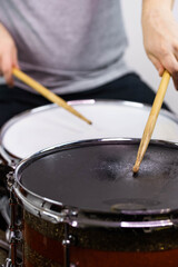 Professional drum set closeup. Man drummer with drumsticks playing drums and cymbals, on the live...
