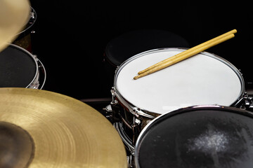 Closeup of drumsticks lying on the professional drum set. Drummer equipment. 