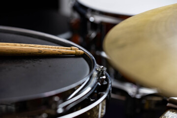 Closeup of drumsticks lying on the professional drum set. Drummer equipment. 