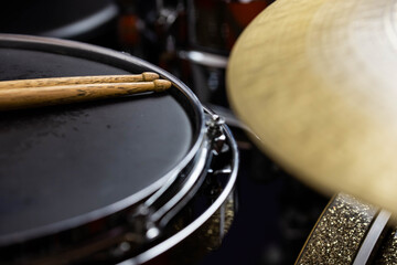 Closeup of drumsticks lying on the professional drum set. Drummer equipment. 