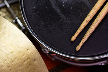 Closeup of drumsticks lying on the professional drum set. Drummer equipment. 