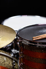Closeup of drumsticks lying on the professional drum set. Drummer equipment. 