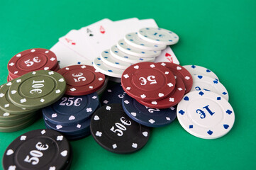 Poker cloth, a deck of cards, poker hand and chips. Background.