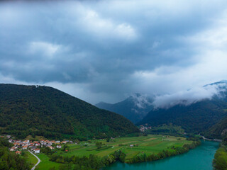 Aerial view of Most Na Soci lake in beautiful colors near Tolmin in Slovenia. Summer cloud day. Travel and vacation.