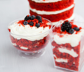 homemade portioned dessert red velvet decorated with berries on a light wooden background