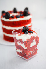 homemade portioned dessert red velvet decorated with berries on a light wooden background