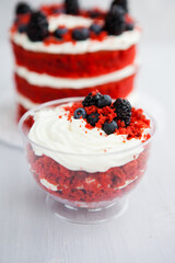 homemade portioned dessert red velvet decorated with berries on a light wooden background
