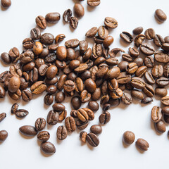brown coffee beans lie on a light background.