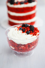 homemade portioned dessert red velvet decorated with berries on a light wooden background