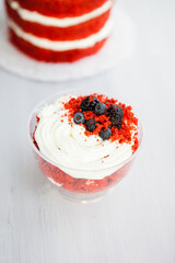 homemade portioned dessert red velvet decorated with berries on a light wooden background