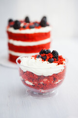 homemade portioned dessert red velvet decorated with berries on a light wooden background