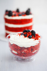 homemade portioned dessert red velvet decorated with berries on a light wooden background