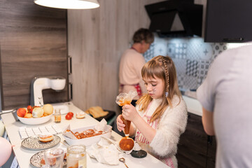 Grandmother and granddaughter preparing doughnuts at home