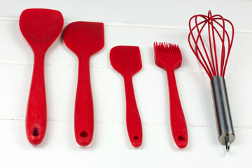 
Set of red kitchen utensils on white background