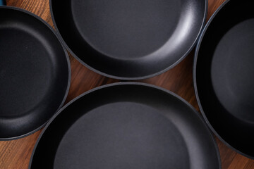 Set of grill pans on wooden table background