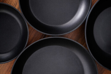 Set of grill pans on wooden table background