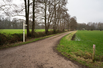 Fototapeta na wymiar Sign post for Weverstraat (Weaverstreet) in Loenen, the Netherlands, at the edge of Veluwe and IJsselvallei (IJssel Valley)