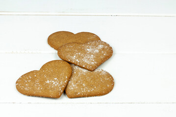 Various heart shaped gingerbread cookies on white background
