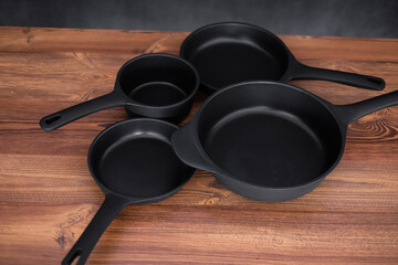 Set of grill pans on wooden table background