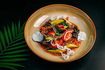 salad with eggplant, zucchini and meat on a decorated table