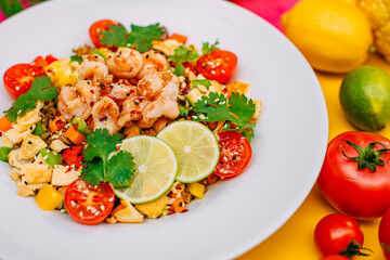 healthy food, salad with shrimps and vegetables with rice on a decorated table