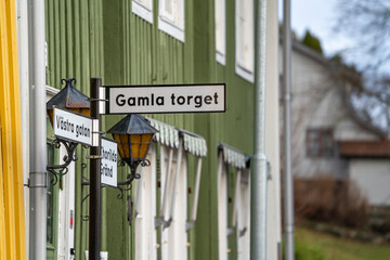 A pole, with city or street names and directions, placed on Old Square Street in Kungalv City,...