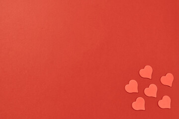 Red heart on a red background. Monochrome with a symphol of love for a card and a gift for the holiday of saint valentine. Postcard card for a date and a wedding. High quality photo