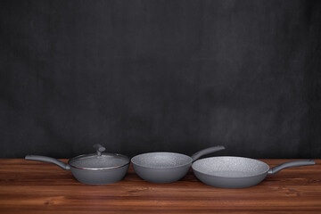 Set of pots prepared for cooking classes on table