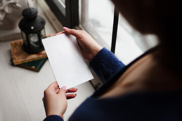 Woman looking at blank white sheet of paper template