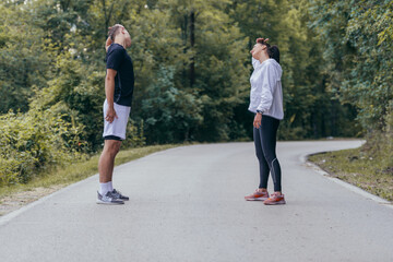 Naklejka premium Male and female athletes preparing for a marathon, run, workout. Healthy lifestyle concept.