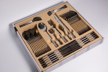 Set of cutlery in a wooden case. Isolated on a white background
