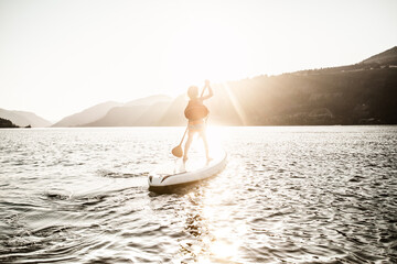 kid learning to paddle board