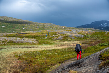 Padjelanta National Park, Beautiful Mountain Scenery and Hiking Trails leading away from Camera with group of hikers trekking and living the wanderlust dream.