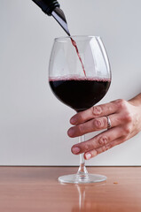 red wine is poured into a glass